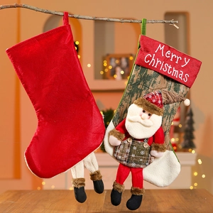 Detail of hanging Christmas stockings with 3D Santa and Merry Christmas text decor
