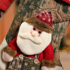 Close-up of Santa Claus plush on a large Christmas stocking with wood-grain pattern and buttons