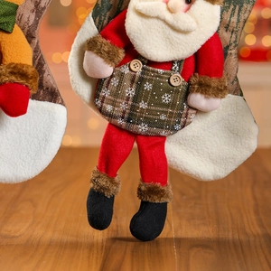 Close-up of 3D Santa Claus Christmas stocking with plaid overalls on wooden background
