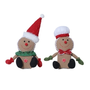Pair of Christmas gingerbread plush figures with hats and corduroy texture on white background