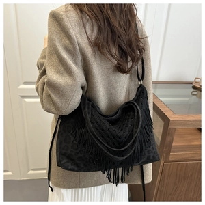 Detailed back view of a black fringe tote bag with leopard print base and crochet mesh