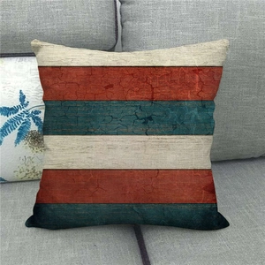 Detail of vintage linen pillowcase featuring red and blue stripes with crackle texture