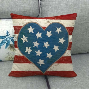 Detail of linen pillowcase with heart star pattern on grey fabric sofa surface
