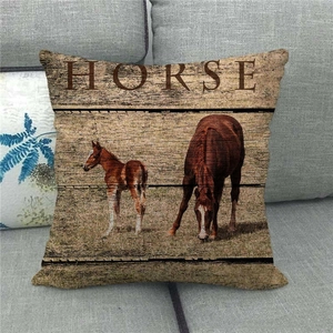 Linen cushion cover with horse print on grey sofa for vintage home decoration