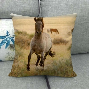 Close-up of linen pillowcase featuring a brown horse running across the African savanna