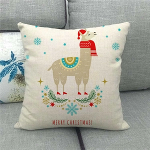 Close-up of linen Christmas pillow cover featuring a cute alpaca and holiday wreath