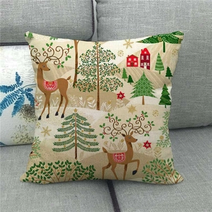 Close-up of linen Christmas pillowcase with cute reindeer and festive trees on a grey sofa