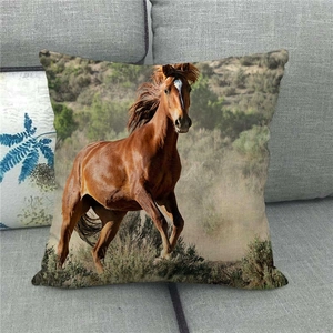 Detailed texture of a linen horse throw pillow placed on a gray fabric sofa