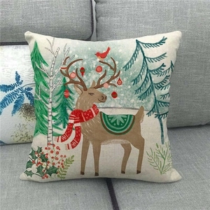 Christmas reindeer linen throw pillow cover with hand-painted deer on a cozy sofa