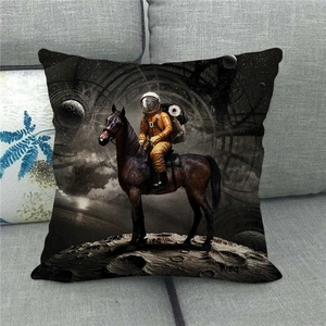 Detail of linen throw pillow featuring an astronaut riding a horse on the moon surface