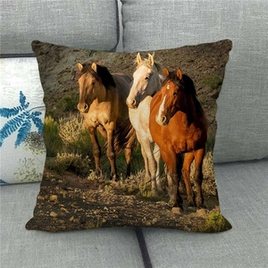 Detailed texture of linen pillowcase featuring three wild horses running on a grey sofa