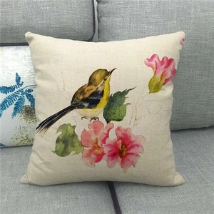 Close-up of linen pillow cover showing bird and watercolor floral pattern detail