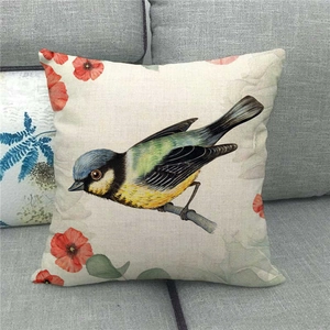 Close-up of bird and red flowers watercolor print on textured linen cushion cover