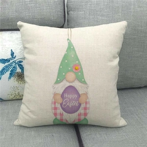 Detail of linen pillowcase with gnome and Happy Easter egg print on a grey sofa