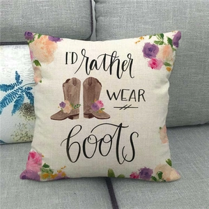 Detail of linen pillowcase with 'I'D Rather WEAR Boots' text and floral boots graphic