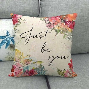 Detailed texture of Home Sweet Christmas wreath linen pillowcase on a grey sofa