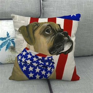 Linen cushion cover with American flag pattern and boxer dog print on a gray sofa