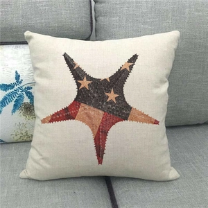 Close-up of star pattern on linen pillowcase with retro red and brown patch design
