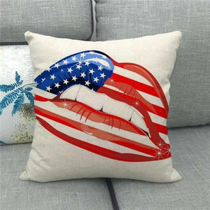 Linen square pillowcase with American flag lip pattern on a grey sofa