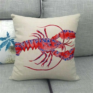 Detailed view of linen pillowcase with watercolor red lobster design on a grey sofa