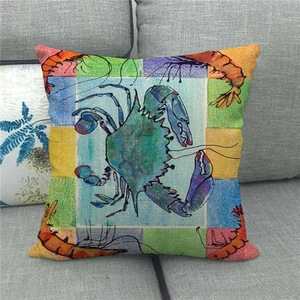Detail of artistic watercolor crab and shrimp print on a textured linen throw pillow