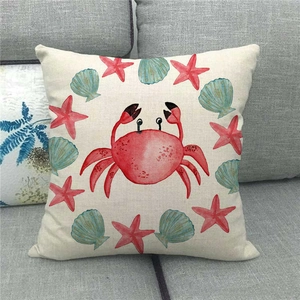 Detailed close-up of watercolor red crab and sea star print on linen pillow cover