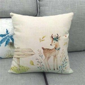 Detail of cute farm deer illustration on a linen throw pillowcase on a grey sofa