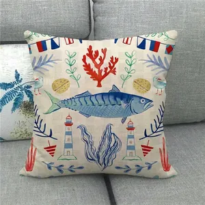 Detail of nautical linen pillowcase with watercolor fish and coral on gray sofa