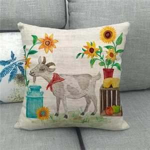 Close-up of linen pillowcase with farm goat illustration and sunflower on a sofa