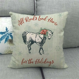 Christmas farm horse linen pillow cover with All Roads Lead Home festive slogan
