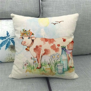 Detailed view of linen cushion cover featuring a hand-painted farm cow and daisy pattern