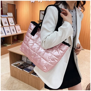 Detail of pink quilted tote bag showing high-gloss nylon fabric and diamond texture