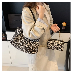 Detail of leopard print canvas tote bag set with metal chain strap and matching pouch