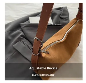 Detail of adjustable silver buckle and brown matte leather strap on a retro shoulder bag