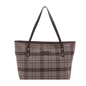Classic grey and brown checkered tote bag with leather straps on white background