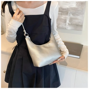 Chic silver crescent bag with knotted strap detail shown on a model for daily styling