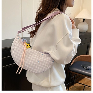 Detail of light purple checkered hobo bag with star prints and yellow star charm