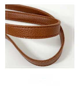 Close-up of brown pebbled leather shoulder strap with smooth oil-edge finish detail