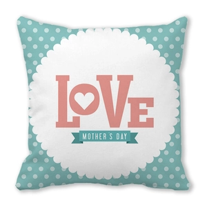 Detail of mint green pillow cover with LOVE and Mother's Day text and white polka dots