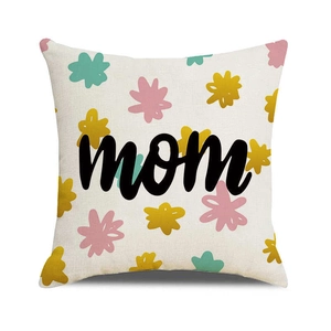 Close-up of linen cushion cover with colorful floral pattern and black mom lettering