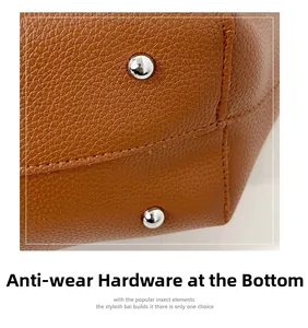 Close-up of brown litchi grain leather bag base with silver metal protective feet
