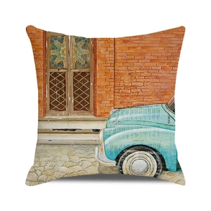 Detailed close-up of a vintage blue car and brick wall print on linen cushion cover