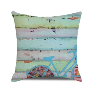 Close-up of a square cotton linen cushion cover with vintage blue bicycle print