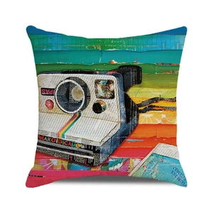 Detail of square cushion cover featuring pop art Polaroid camera and colorful patterns