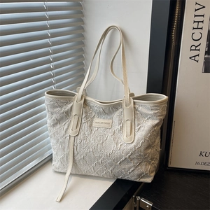 Chic cream-colored shoulder tote bag with bubble texture and floral embroidery