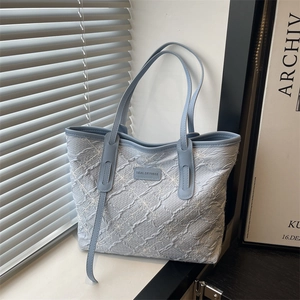 Blue floral textured underarm tote bag with Tidal Dryness logo for casual commute