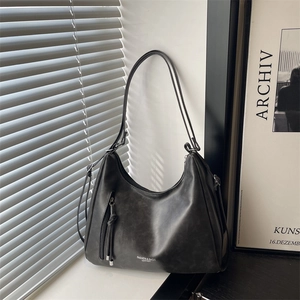 Retro black large capacity shoulder bag with fine leather texture and tassel detail