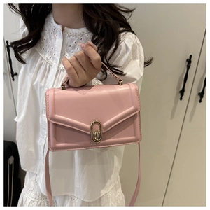 Pink PU leather crossbody bag featuring an elegant gold oval twist lock and slim shoulder strap
