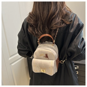 Mini canvas backpack featuring brown cat print and stylish metal chain straps