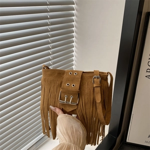 Retro tan suede shoulder bag with long fringe tassels and vintage buckle detail